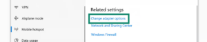 The Windows network settings screen with a green box highlighting the Change adapter options link under the Related settings header.