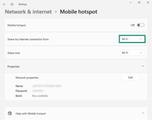 The Windows 11 Mobile hotspot settings screen with a green box highlighting the "Share my internet connection from" dropdown menu, which is set to Wi-Fi.