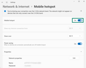 The Windows 11 Mobile hotspot settings screen with a green box highlighting the Mobile hotspot toggle switch set to On.