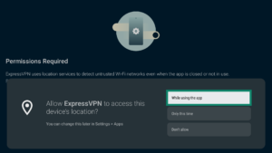 ExpressVPN app interface showing a device location popup on Android TV. The While using the app button is highlighted.